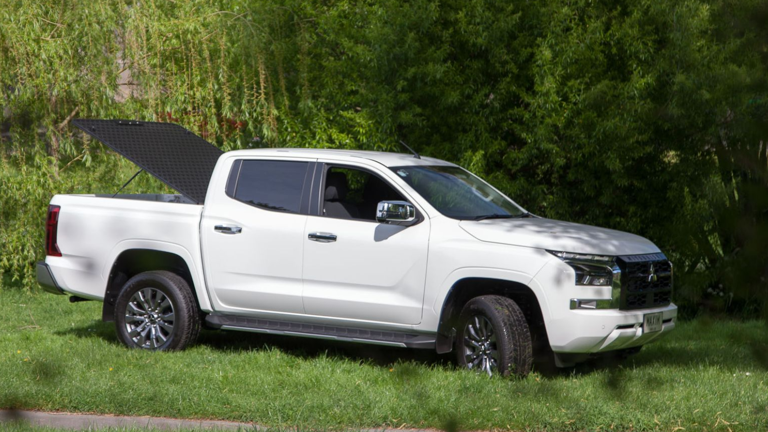 Ford Ranger with MAXIM Hard Lid on the grass.
