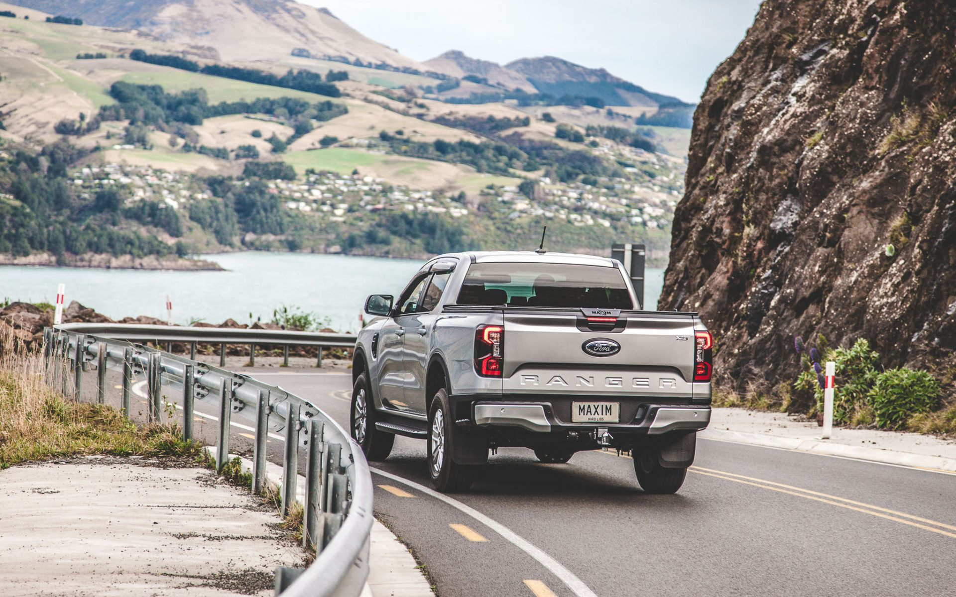 Ford Ranger with MAXIM Hard Lid on a mountainous road with a bay scene 