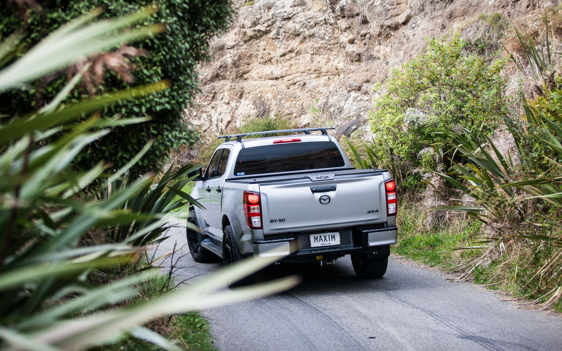 MAZDA BT-50 with MAXIM Hard Lid on road in nature. 