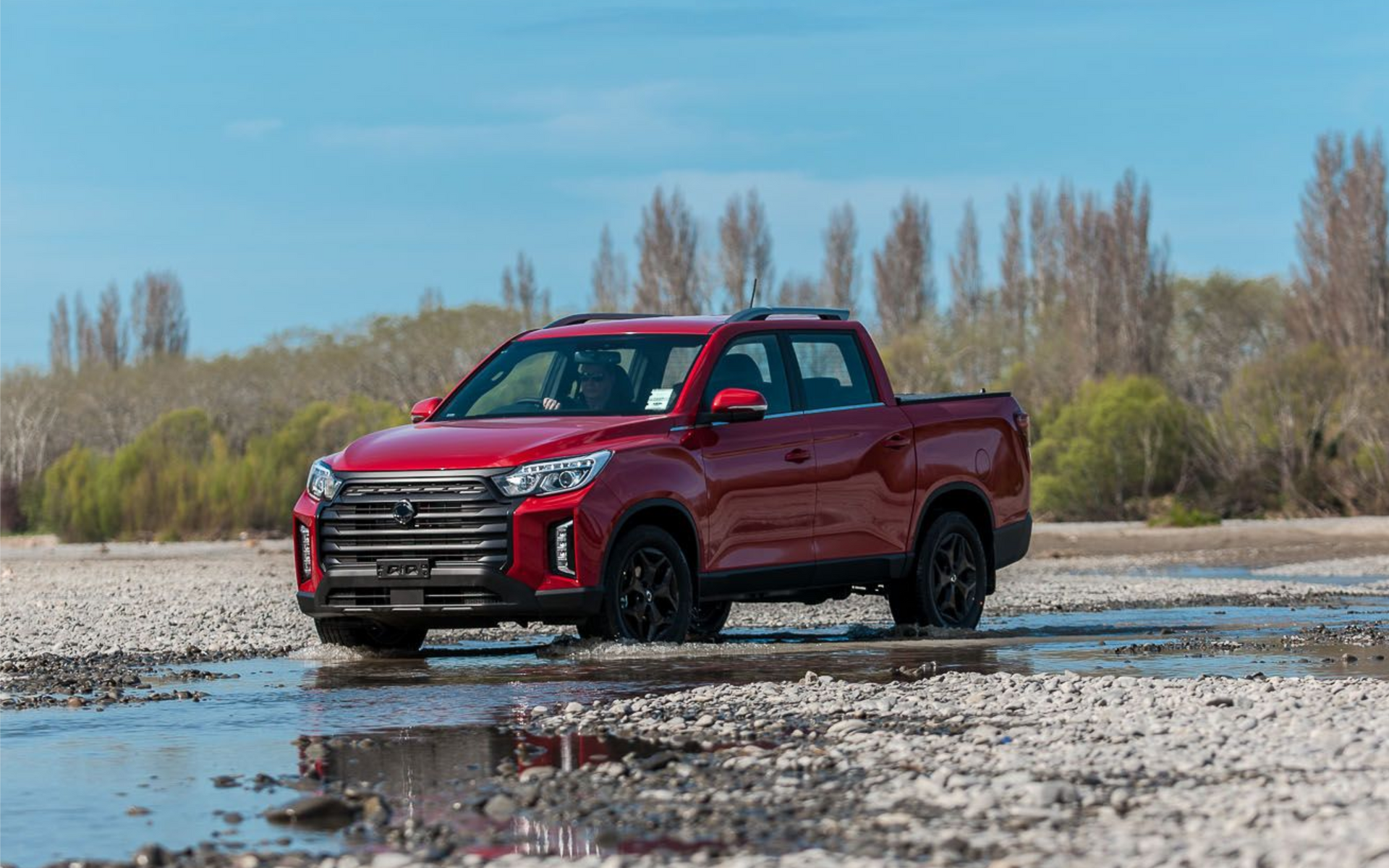 KGM Musso with MAXIM Hard Lid on riverbed.