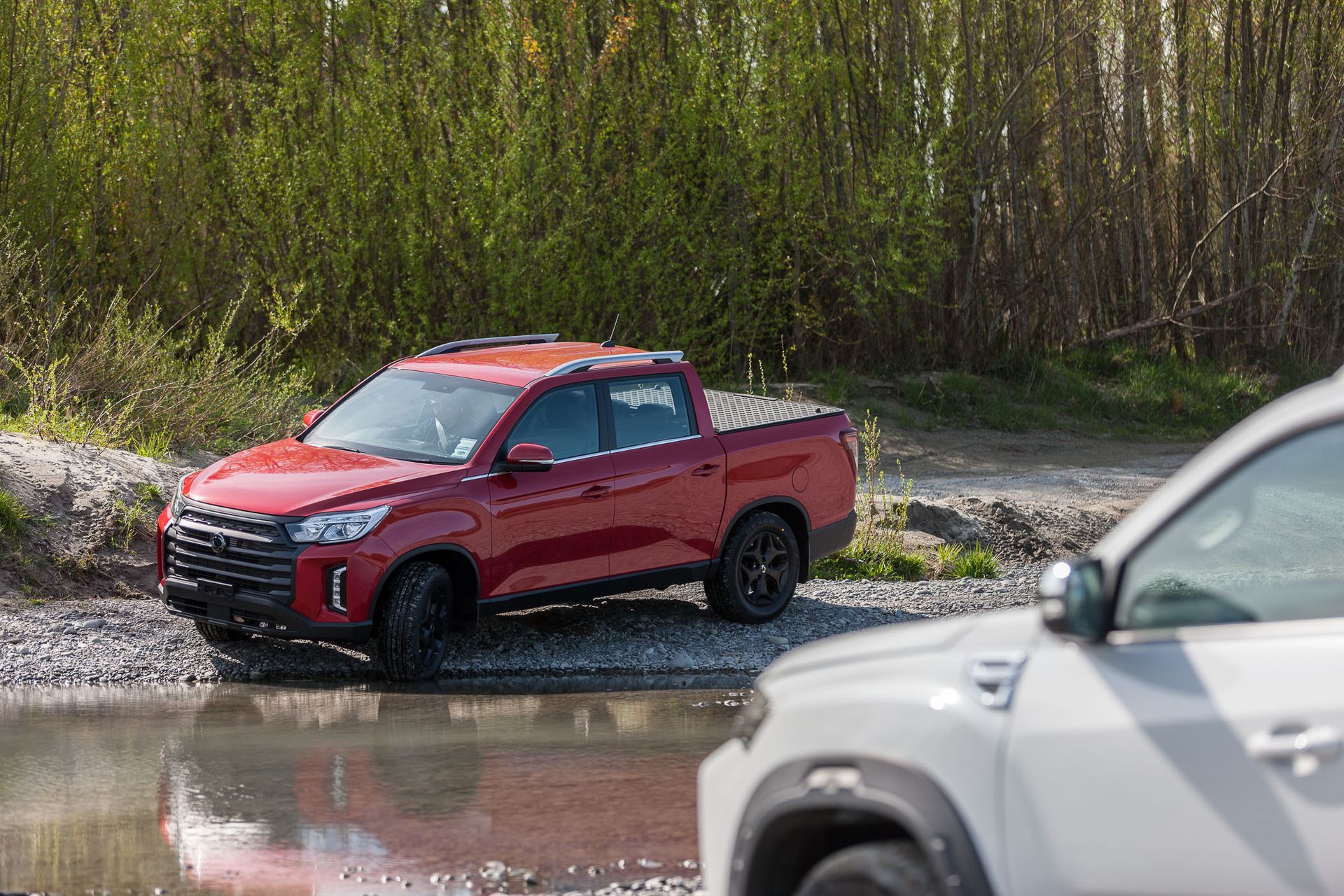 KGM Musso with MAXIM Hard Lid on riverbed.