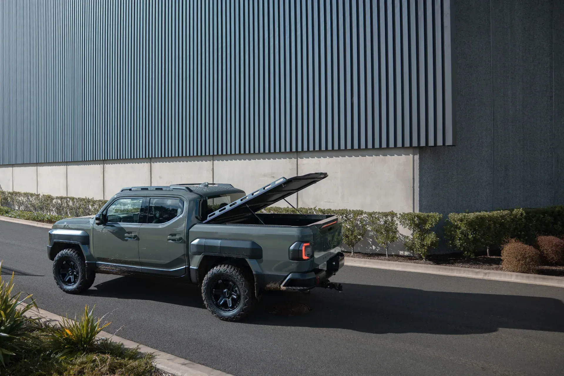 Kia Tasman in an industrial setting.