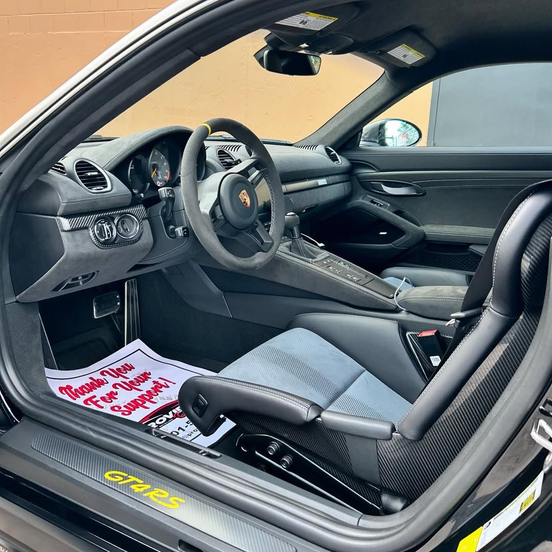 The inside of a porsche gt3 with the door open