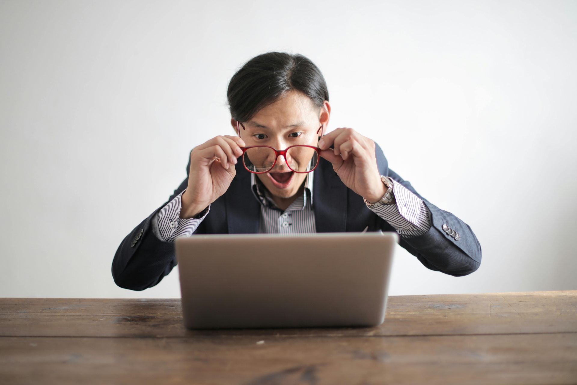 man viewing computer in amazement