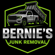 A logo for Bernie’s Junk Removal featuring a silver dump truck inside a green shield outline on a black background.