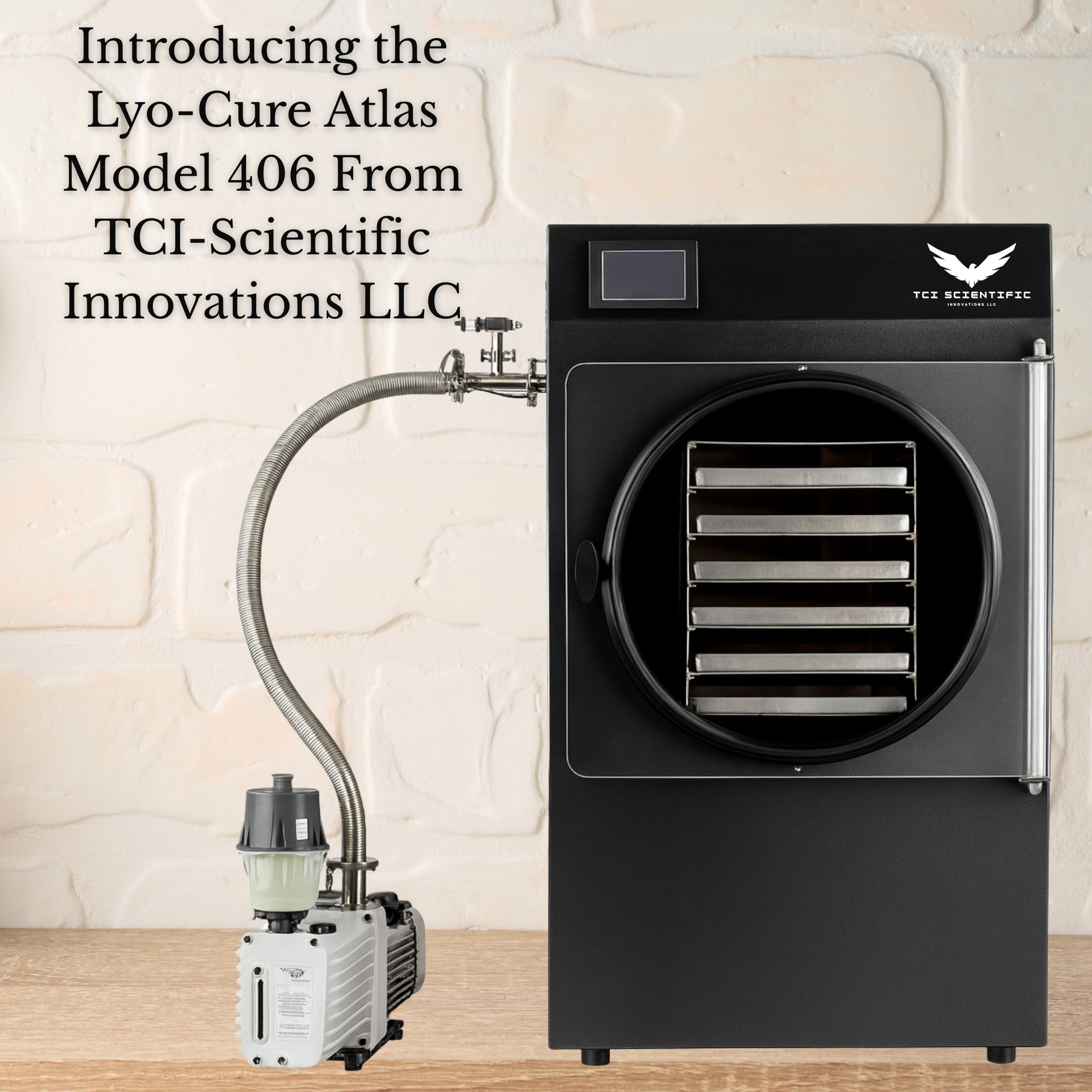 Black Lyo-Cure Atlas Model 406 freeze dryer with connected vacuum pump. Text: TCI-Scientific Innovations LLC.