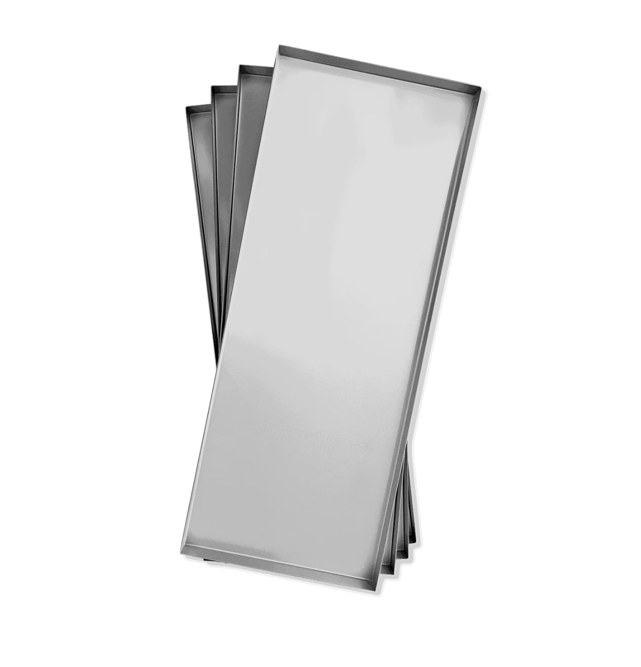 Rectangular, silver baking trays stacked slightly fanned out.