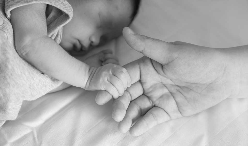 newborn baby holding mother's finger - Heavenly Hands Birthing Center