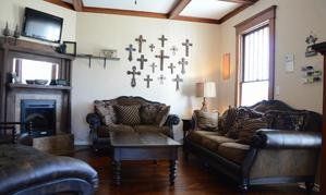 A living room with a couch , chair , coffee table and fireplace.