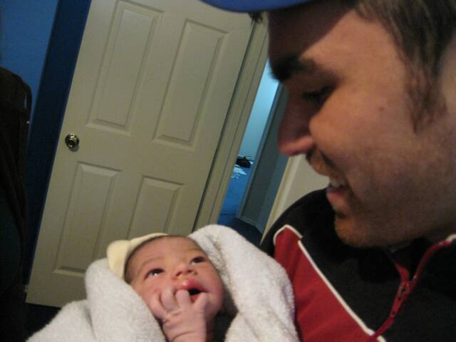 father holding newborn baby - Heavenly Hands Birthing Center