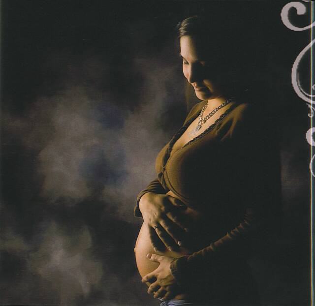pregnant woman holding belly - Heavenly Hands Birthing Center