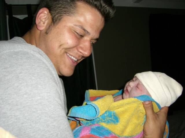 father holding newborn baby - Heavenly Hands Birthing Center