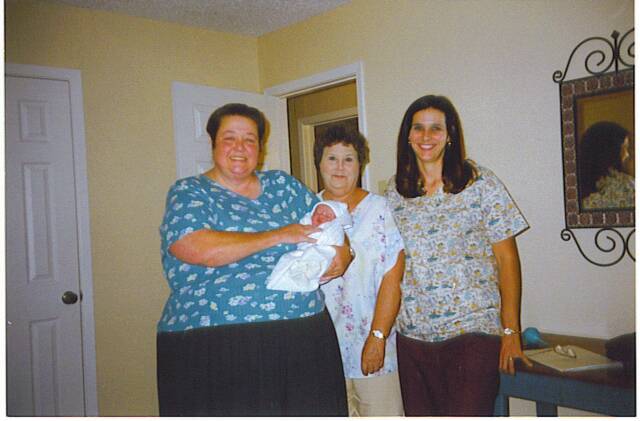 women holding newborn baby - Heavenly Hands Birthing Center