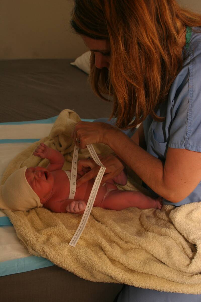 midwife measuring newborn baby - Heavenly Hands Birthing Center