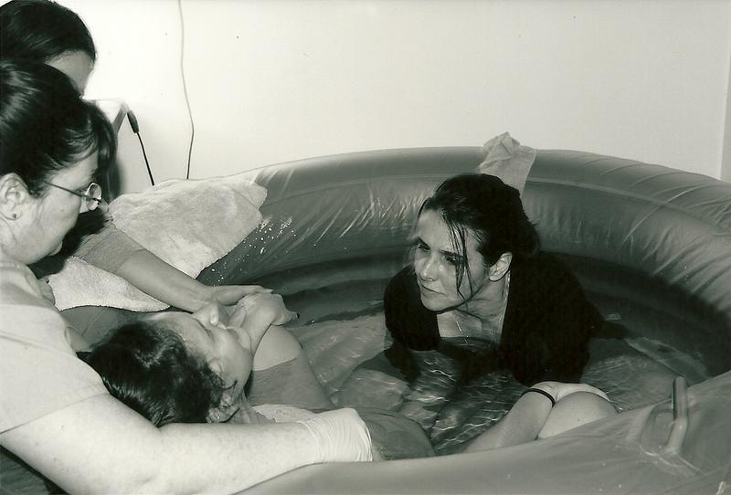 midwife coaching mother through water birth - Heavenly Hands Birthing Center