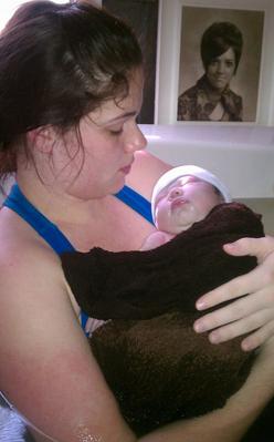 mother holding newborn baby just after water birth - Heavenly Hands Birthing Center