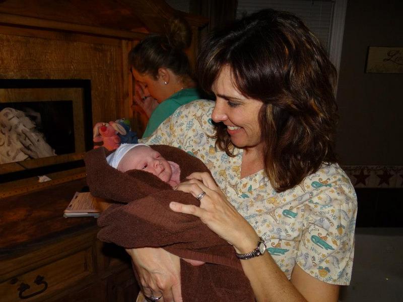 tina holding newborn baby just after water birth - Heavenly Hands Birthing Center