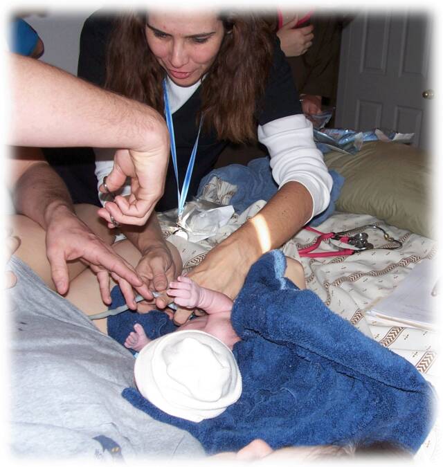 father cutting umbilical cord - Heavenly Hands Birthing Center