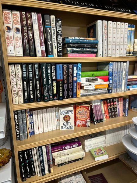 Bookshelf filled with colorful manga and books in a room