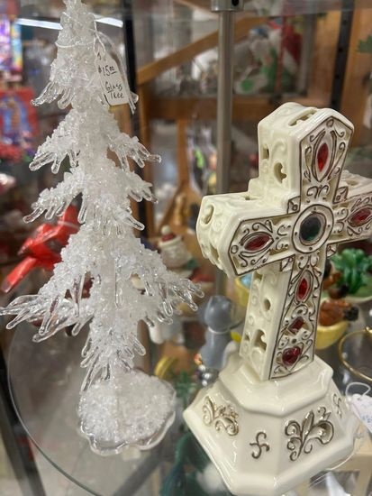 Decorated Christmas tree with red, gold, and white ornaments, bows, and lights in a festive indoor setting