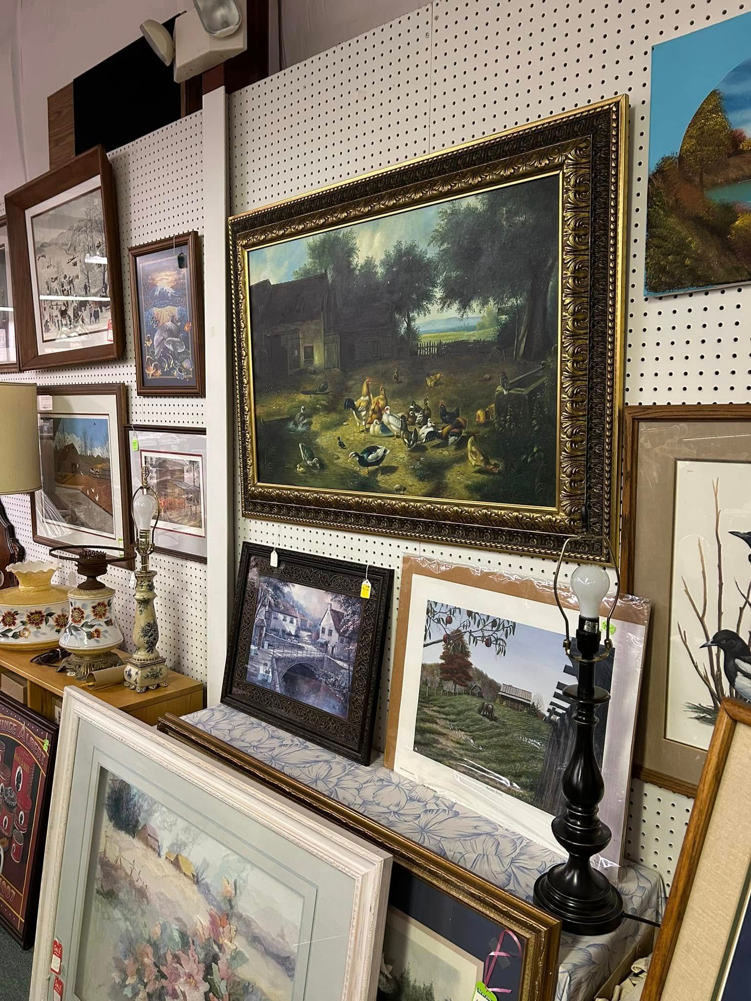 Halloween craft display with orange-and-black plush decorations, garlands, and small spooky figurines on shelves