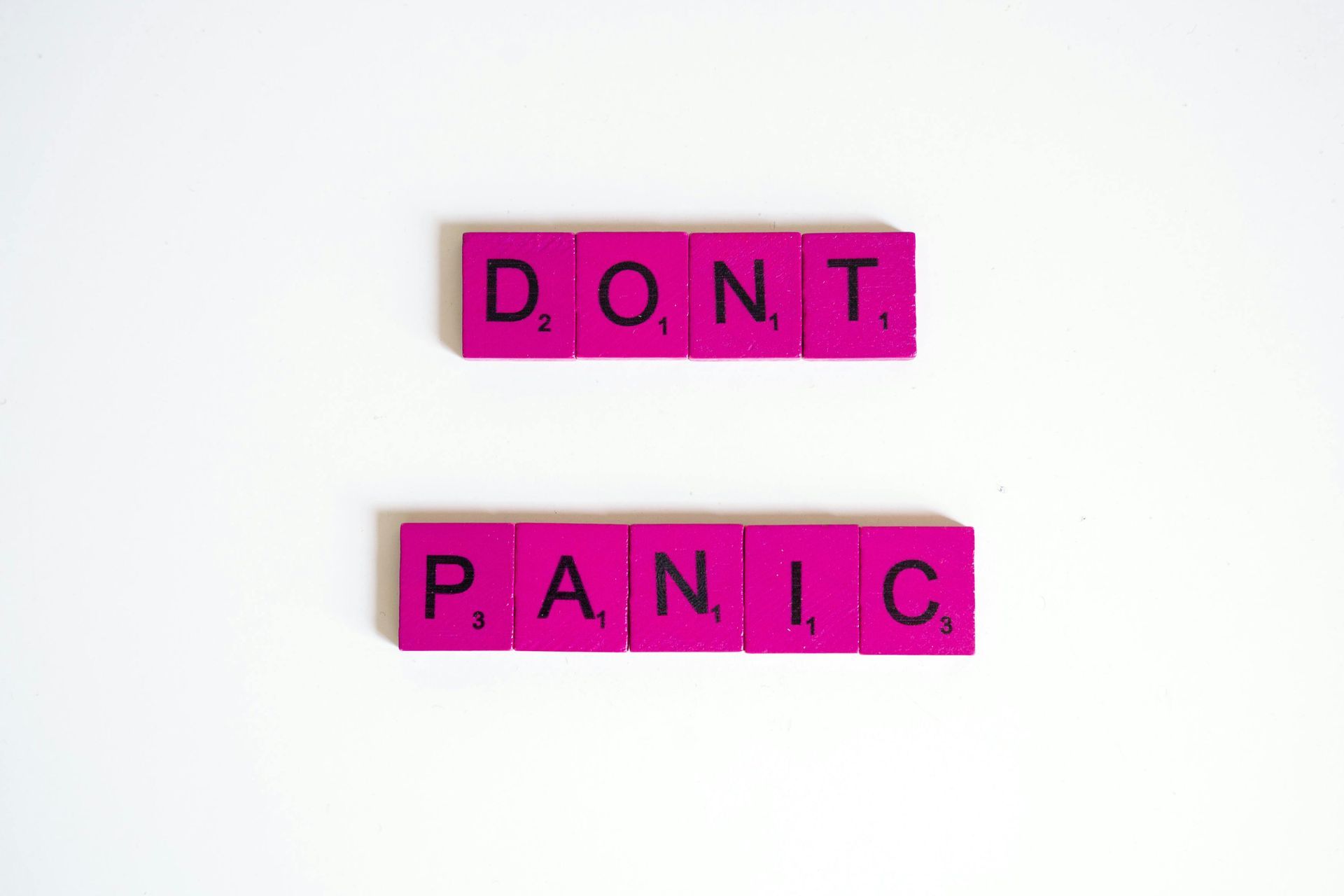 Pink Scrabble tiles spell 