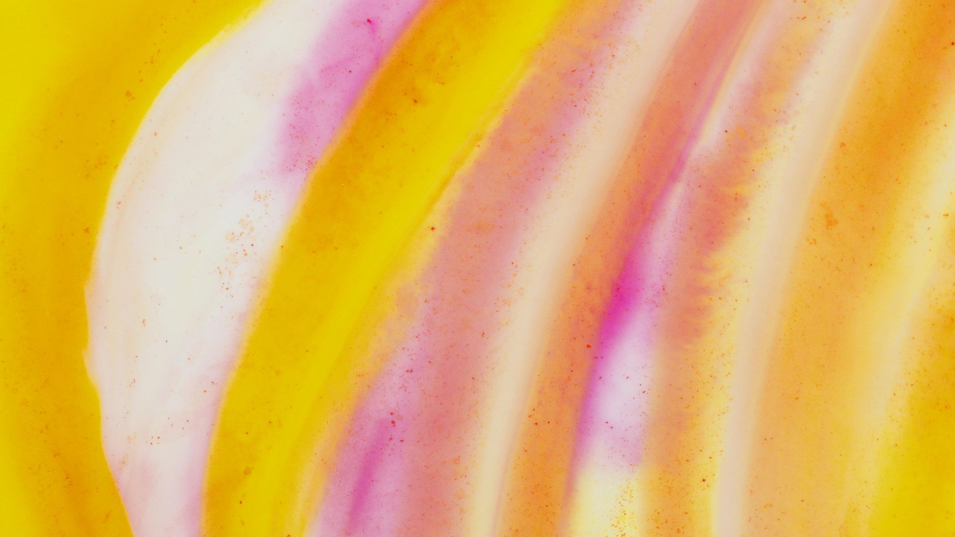 Abstract watercolor with yellow, orange, and pink blending in curved strokes.