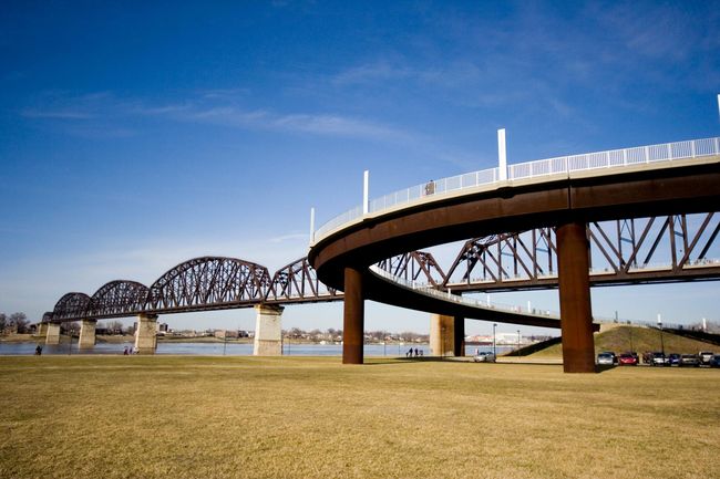 A bridge over a body of water with a blue sky in the background