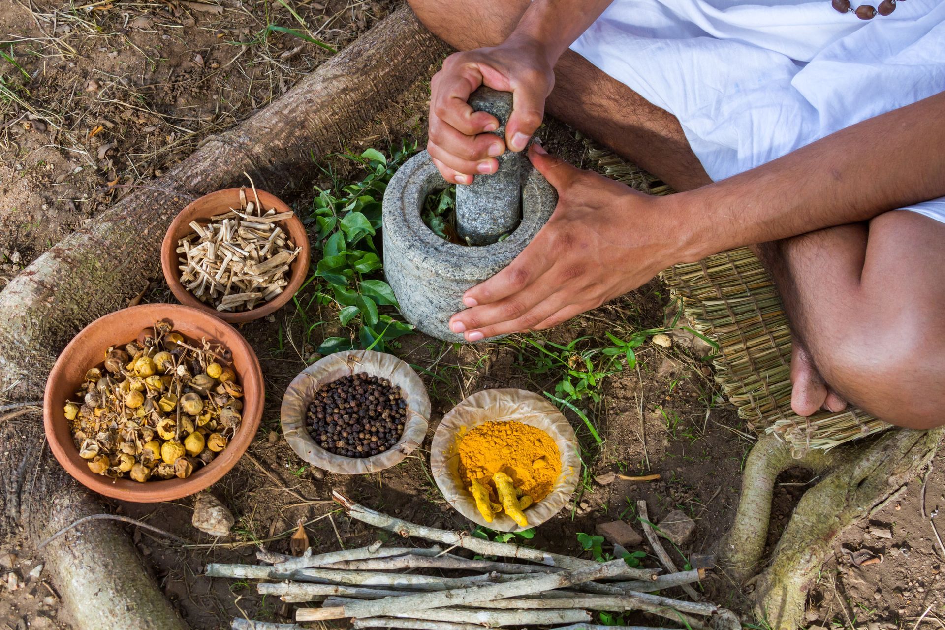 A person is grinding spices with a mortar and pestle.
