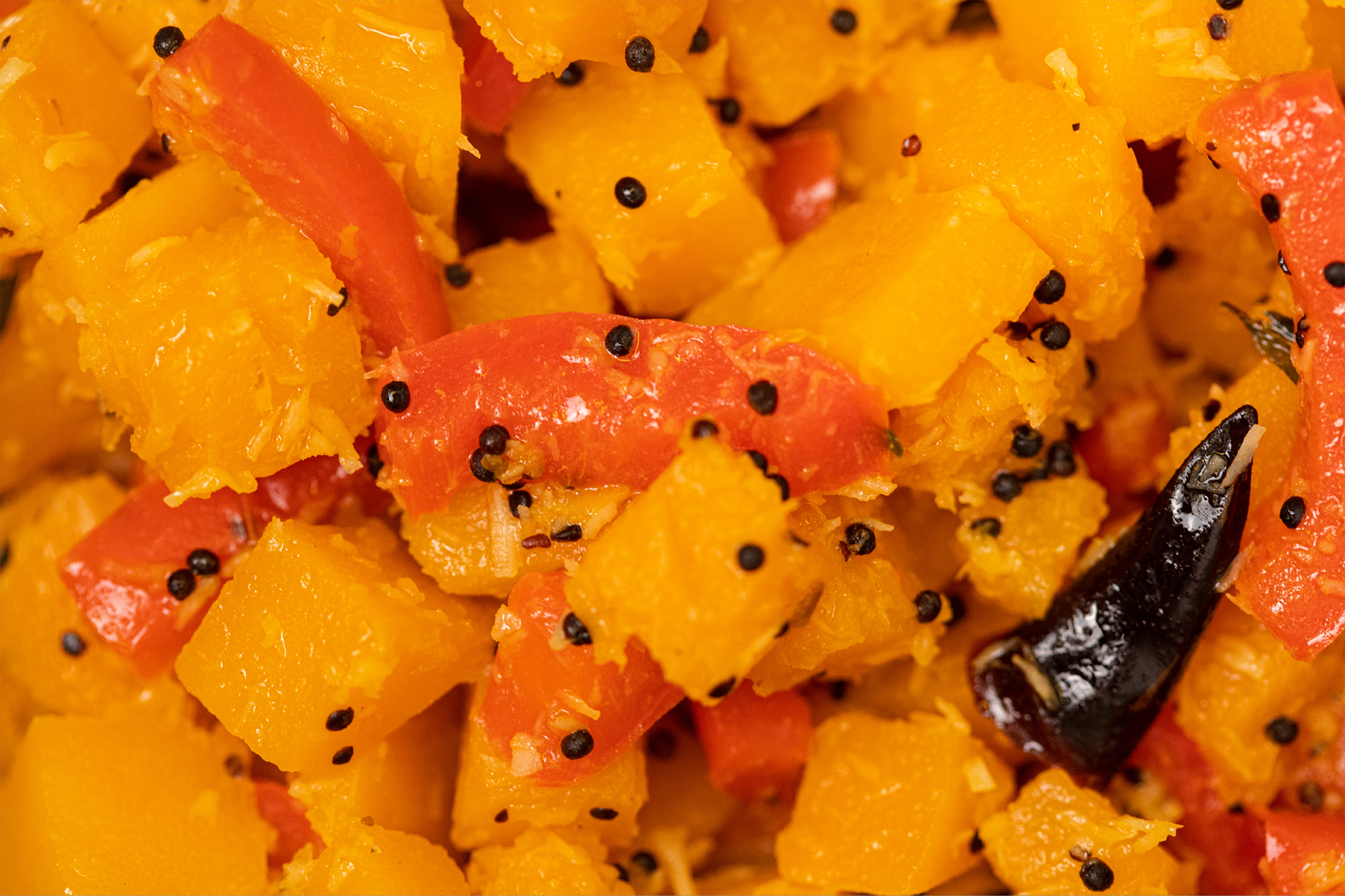 A close up of a bowl of food with vegetables and spices.