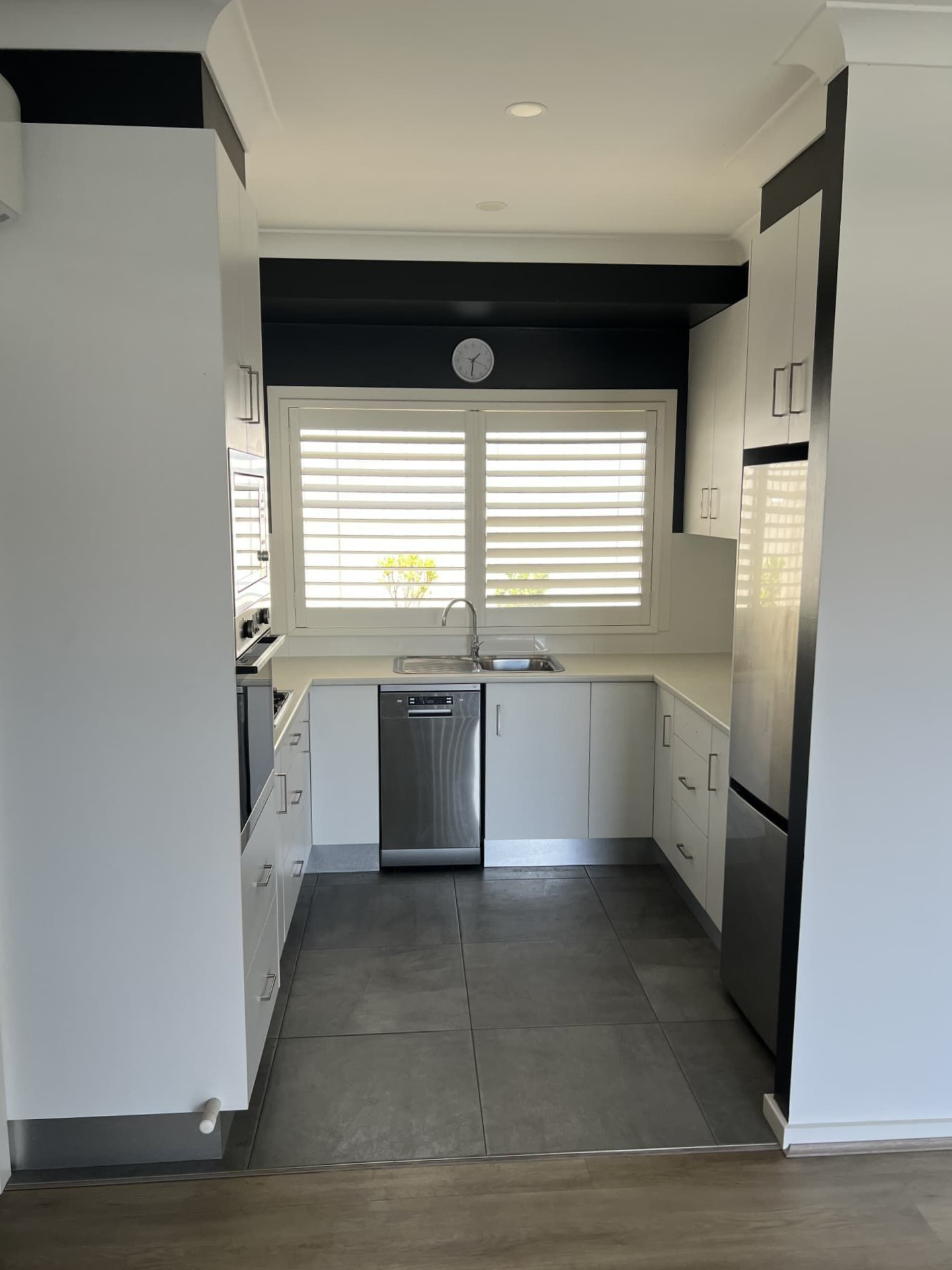 A Modern U-shaped Kitchen With White Cabinets — Taddeo Constructions in Shellharbour, NSW