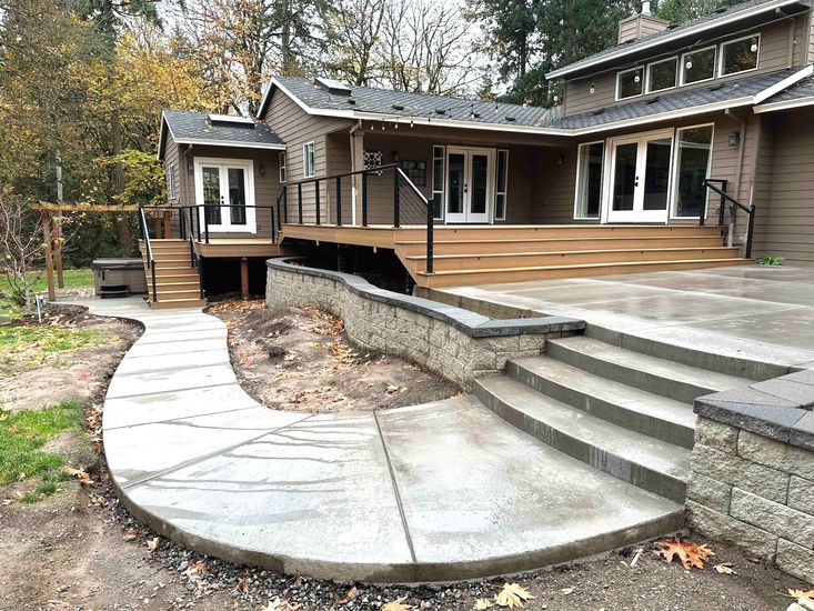 there is a concrete walkway leading to the back of the house .