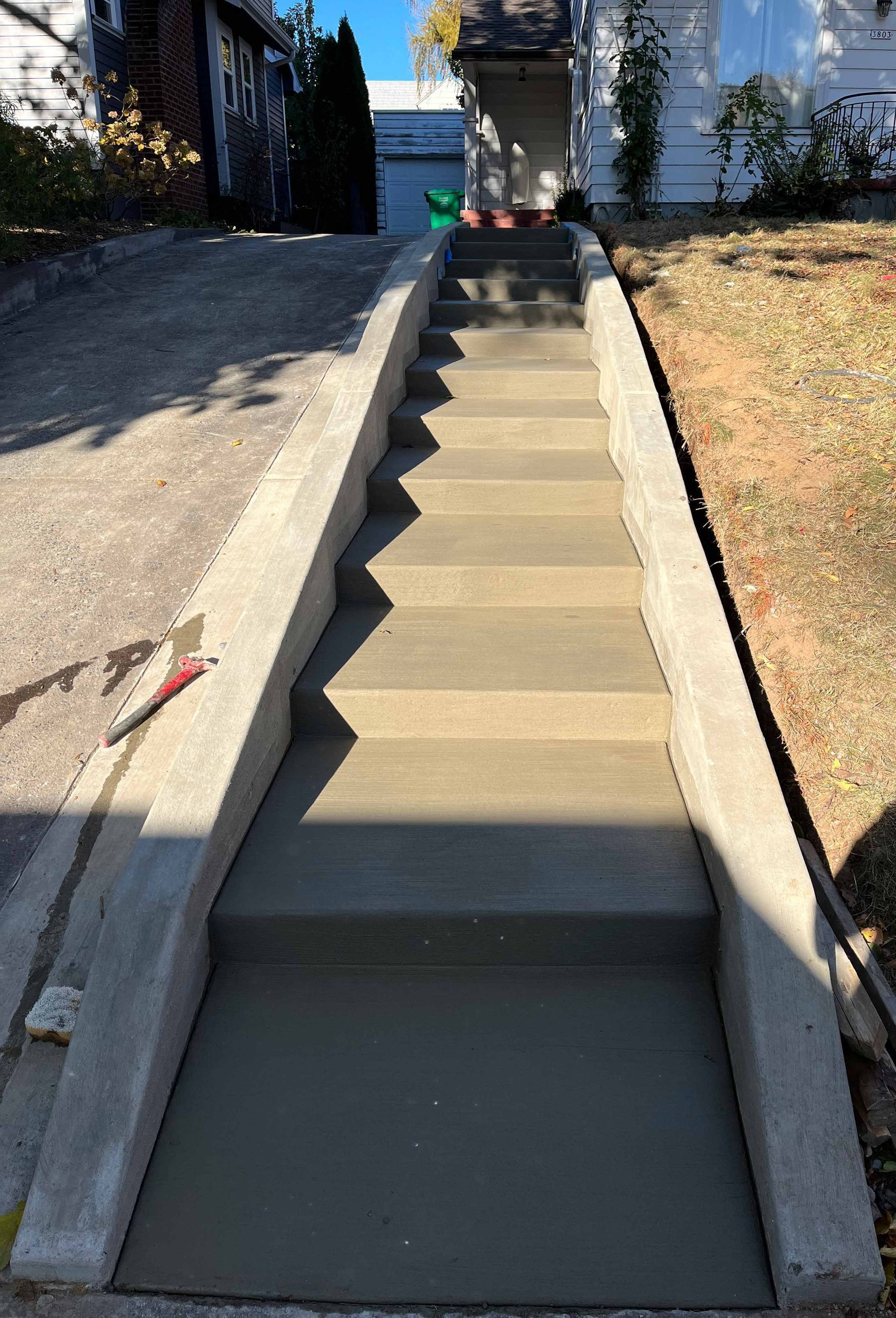 A set of concrete stairs leading up to a house in Portland OR