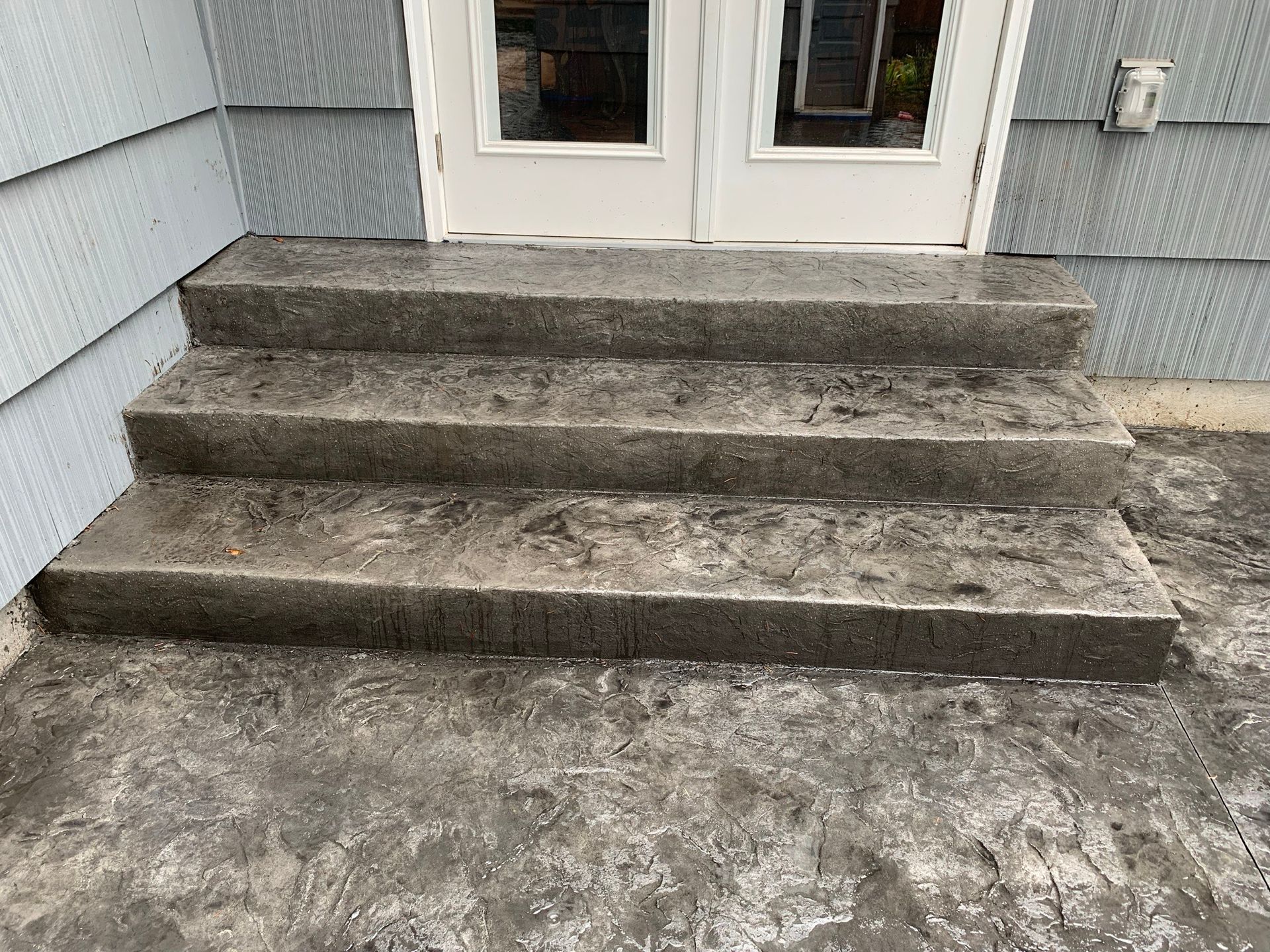 a set of concrete steps leading up to a door in Portland OR