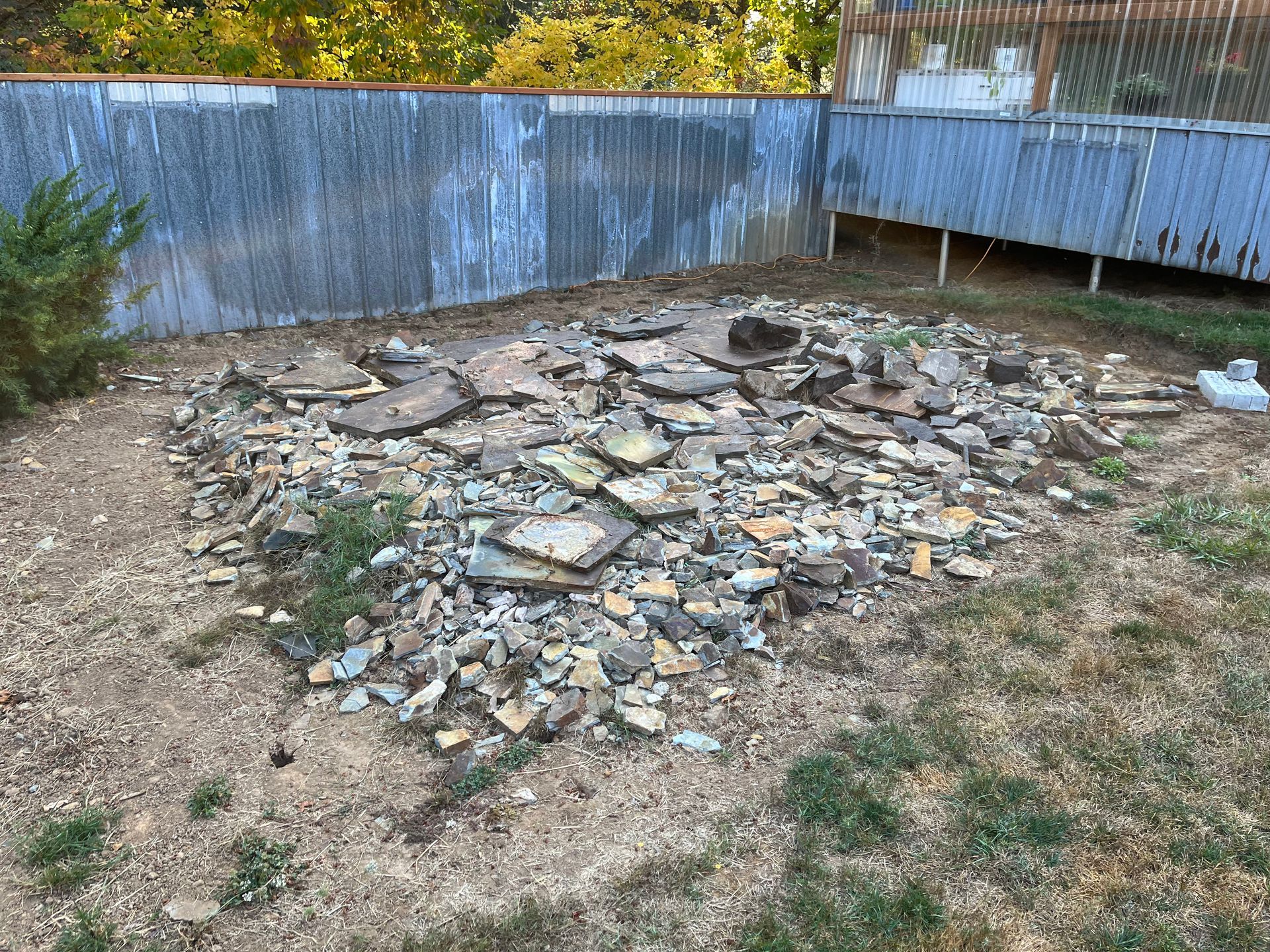 There is a pile of rocks in the middle of the yard.