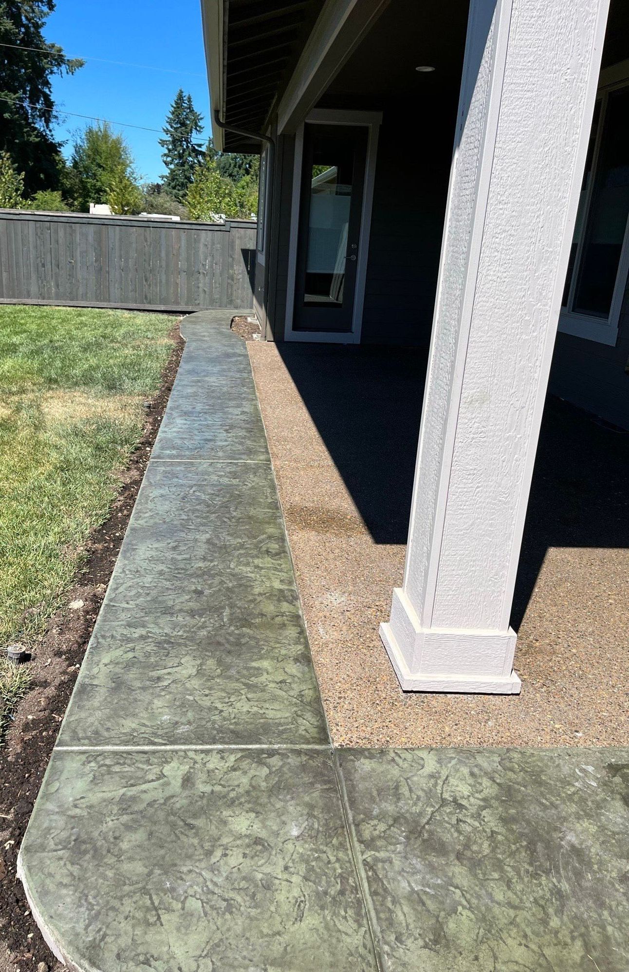 a concrete walkway leading to a porch of a house in Portland OR