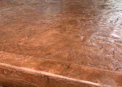 A close up of a brown concrete floor with a marble texture in Portland OR