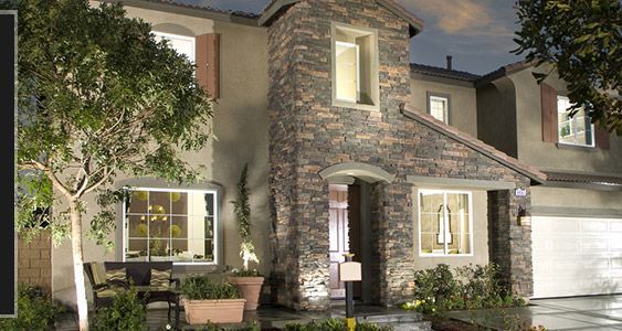A large stone house with a lot of windows and trees in front of it.