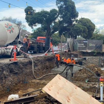 A concrete mixer is being used to mix concrete at a construction site.
