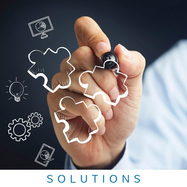 A hand uses a marker to draw three white puzzle pieces on a dark background surrounded by business icons.