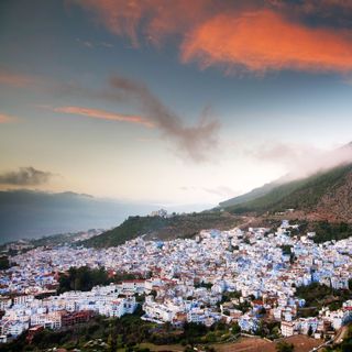 A scenic view of an ancient Moroccan town nestled in the mountains.
