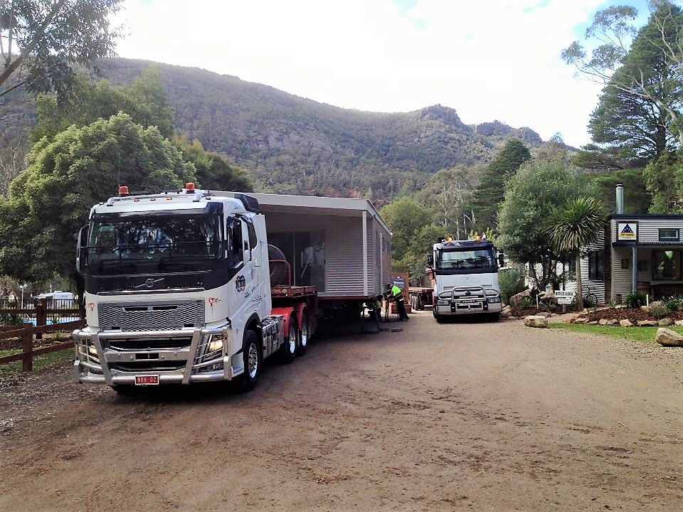 A white truck with the word over on the side of it