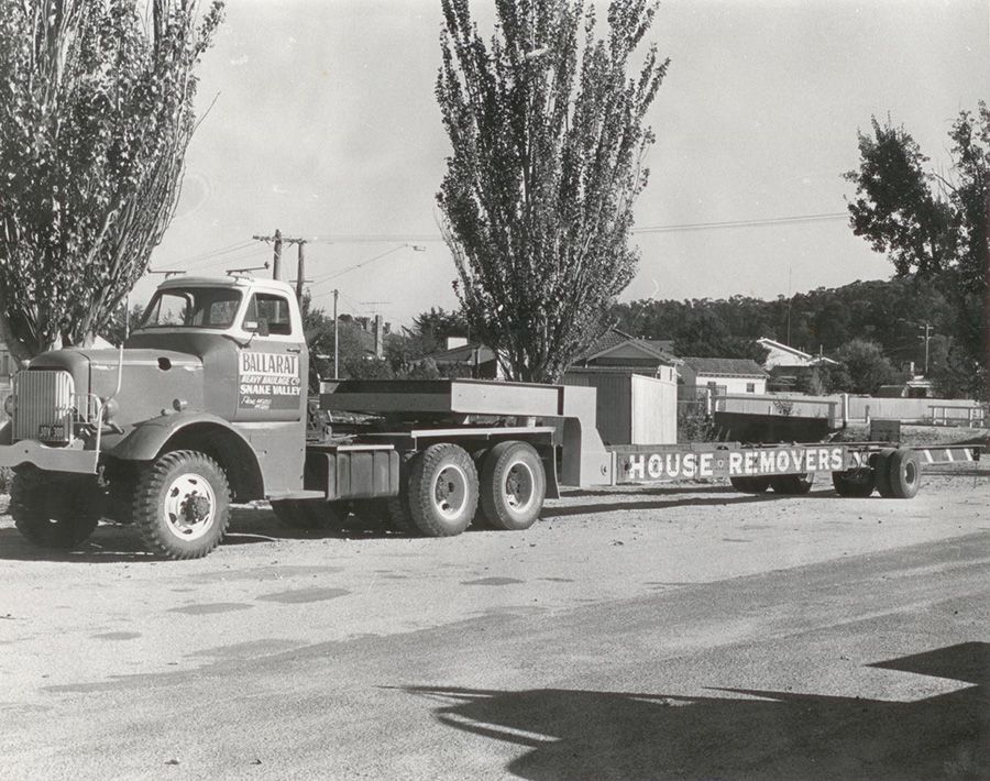 A black and white photo of a house remover truck