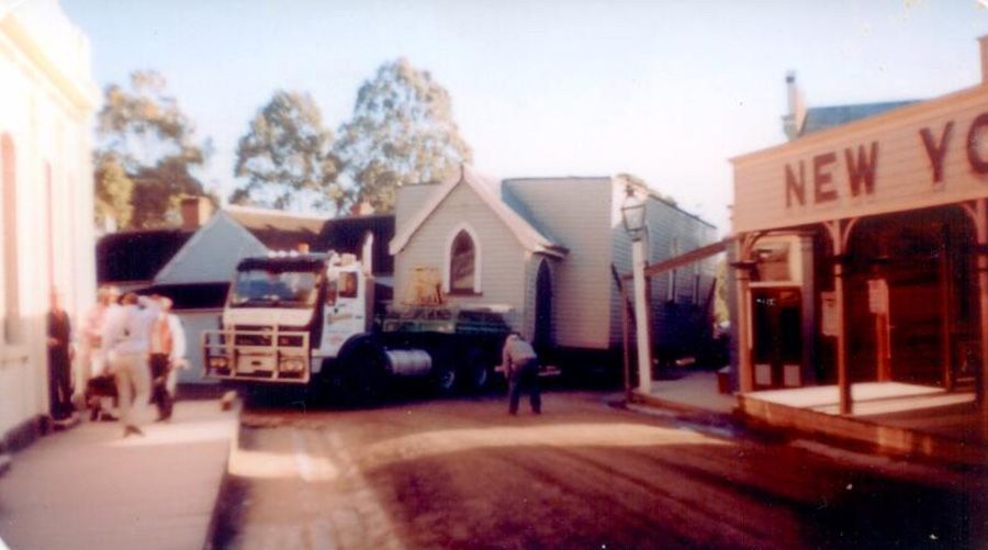 A truck is parked in front of a building that says new york