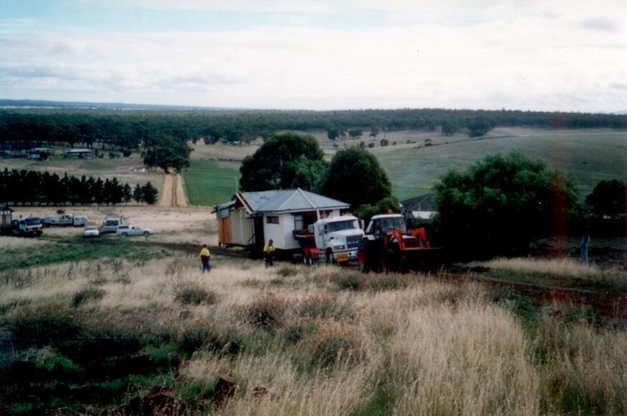 A house is being moved to a new location in a field.