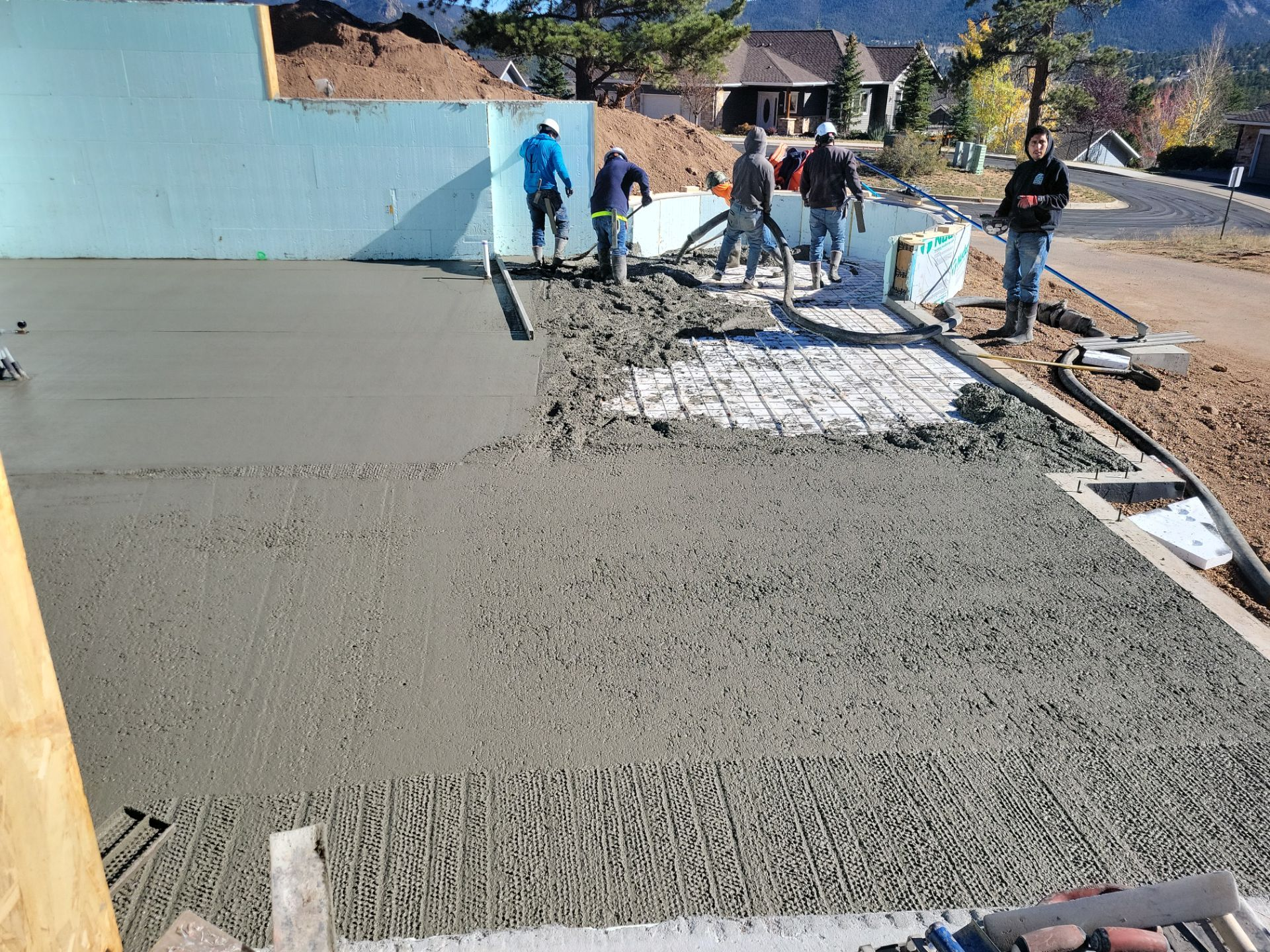 Modern lounge with bar, tables, seating, brick wall, and dark ceiling.