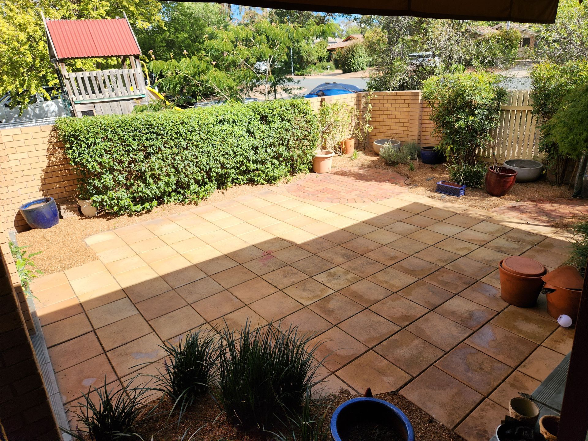 After A Fence Surrounds A Yard With A House In The Background — Canberra Home and Garden Maintenance in Tuggeranong ACT