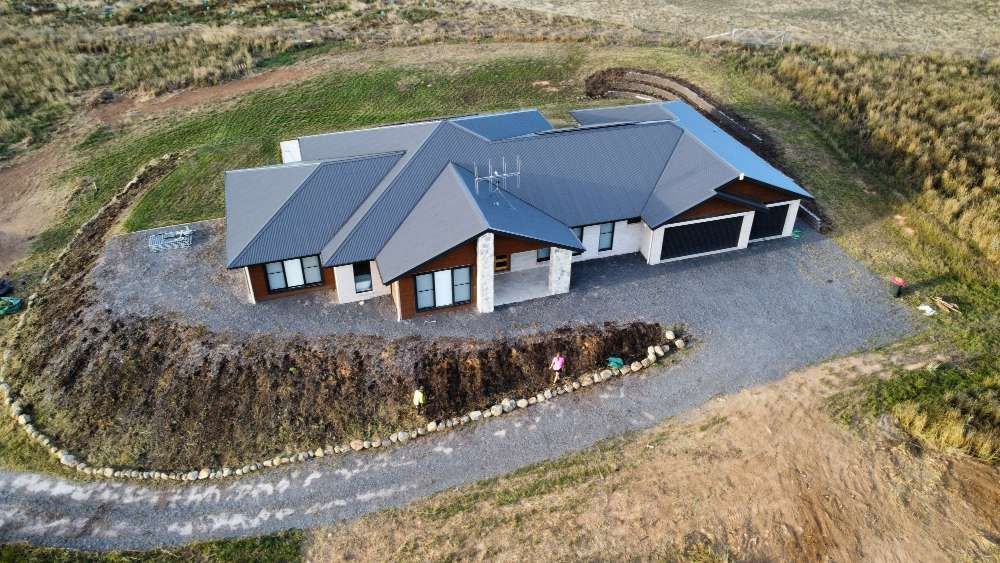 After An Aerial View Of A House Sitting On Top Of A Hill — Canberra Home and Garden Maintenance in Tuggeranong ACT