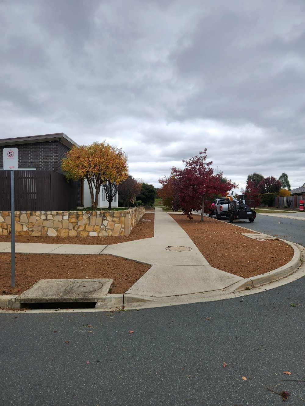 After A Corner Of A Street With A Sidewalk And A House In The Background — Canberra Home and Garden Maintenance in Tuggeranong ACT