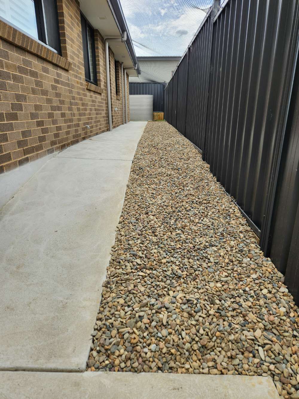 After A Brick Building With A Gravel Walkway Leading To It — Canberra Home and Garden Maintenance in Tuggeranong ACT